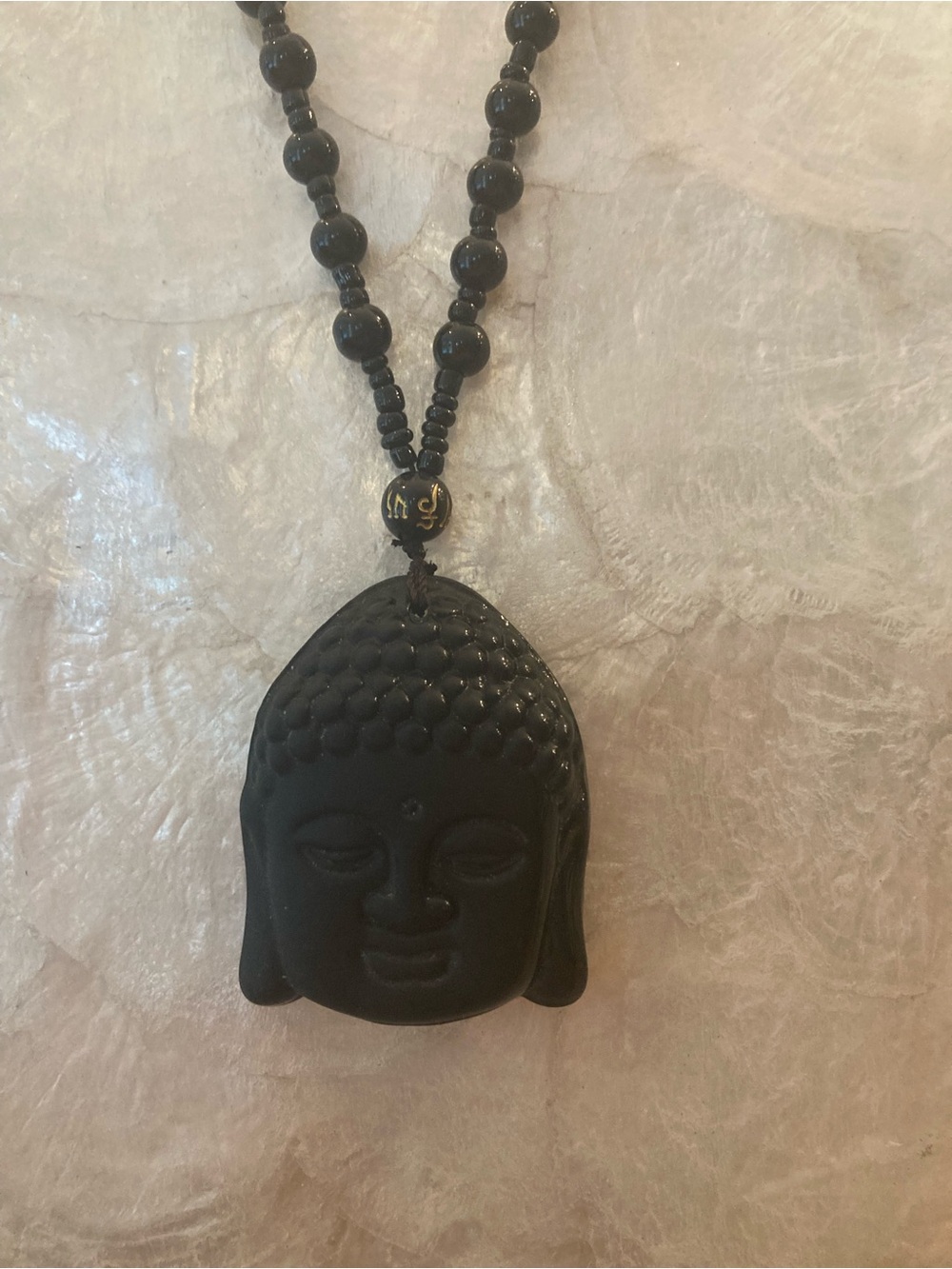 Black stone carved Buddha Head Pendant Necklace - beaded knotted chain.